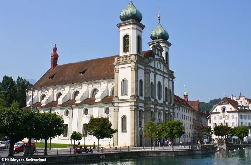 The twin-domed Jesuit Church in Lucerne sits alongside the River Reuss.