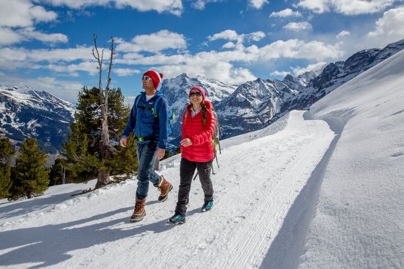 Couple hiking in Grindelwald Switzerland in winter